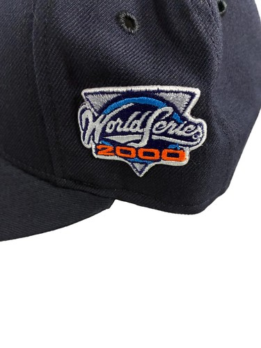 Navy New Era NY Yankees fitted hat with white embroidered World Series 2000 logo in blue, red, and white on the front panel.