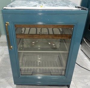 Sub-zero UC-24B. Beverage center. Custom Sherwood green panel attached