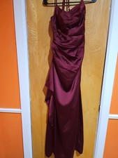 Elegant floor-length satin gown in a deep burgundy hue. Features delicate spaghe