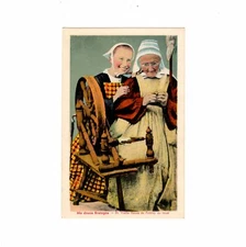 Postcard women in costume on the spinning wheel