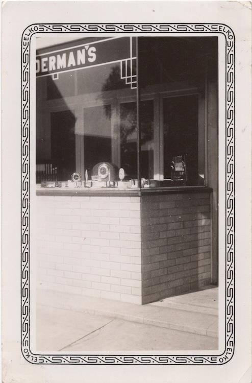 Display of clocks in store window, 1930s