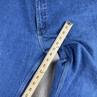Blue denim Y2K Carhartt men’s carpenter jeans with faded thighs, five-pocket design, and metal rivets, USA Made label visible.