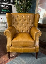 Tan leather armchair with button back