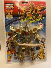 Transformers robot toy the figure is gold -colored with Silver and red accents