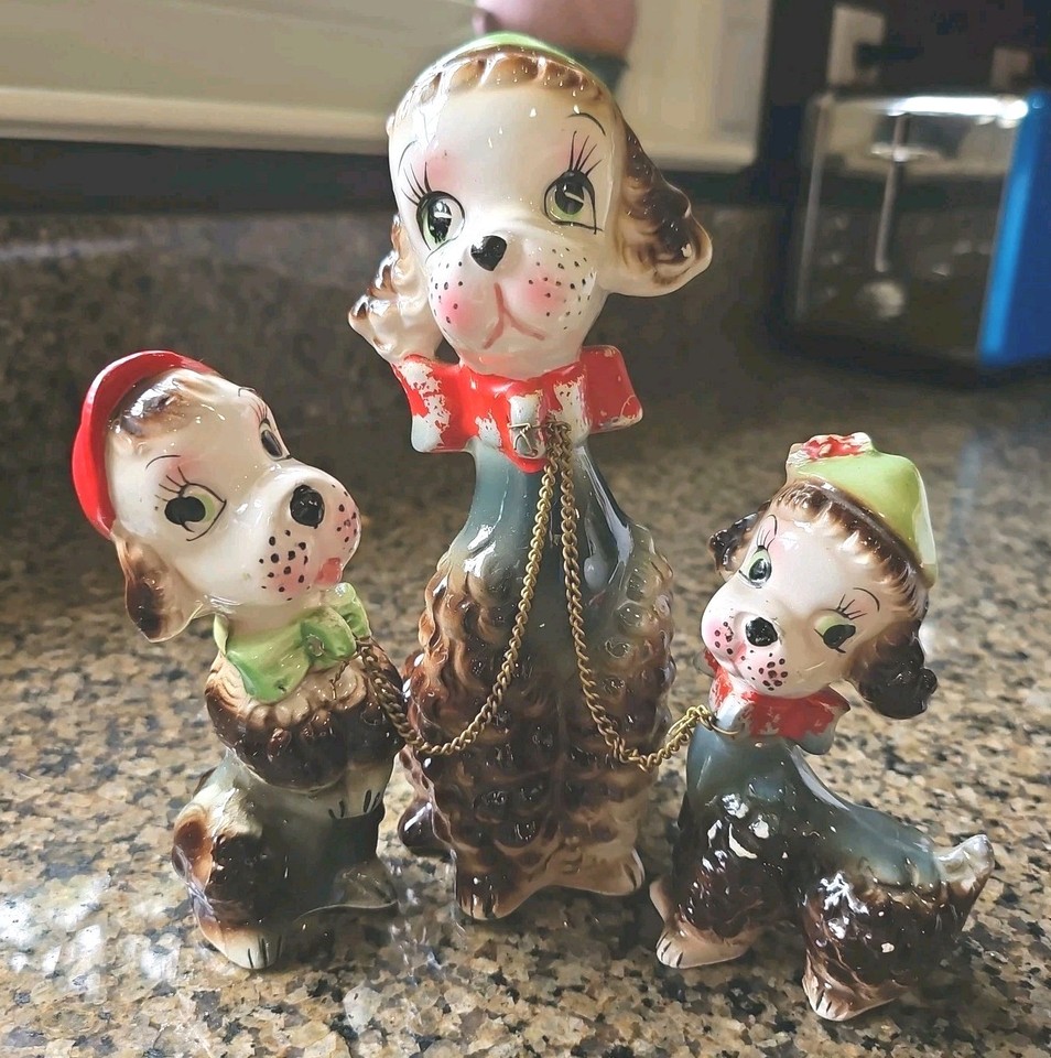 A genuine 1950s kitsch collectible — a chained mama dog with babies is exactly the kind of wonderfully weird mid-century novelty that makes vintage hunters lose their minds.