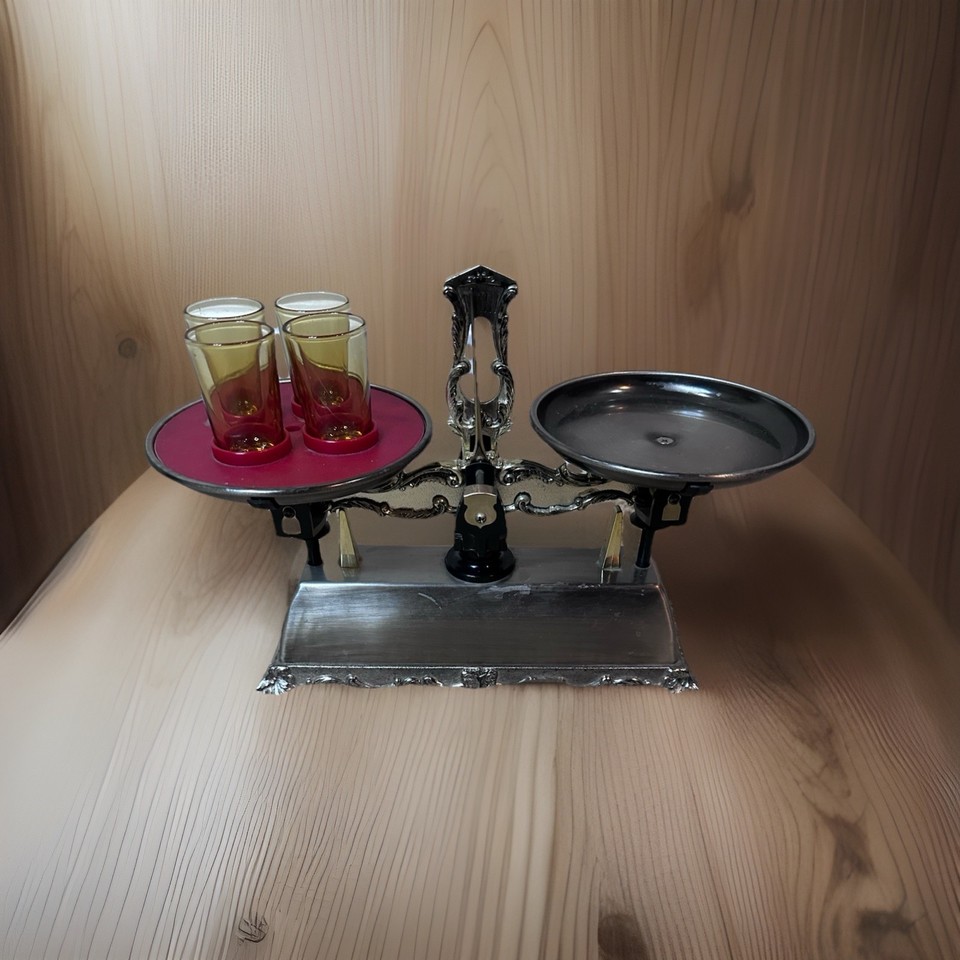 A 1970s decanter built into a working musical box shaped like a scale — it plays music AND dispenses spirits, which is absolutely unhinged in the best possible way.
