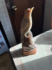 Decorative Bird perched on pedestal carved out of horn on wooden base