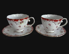 A pair of Grace's teaware pink rose teacup and saucer with gold trim