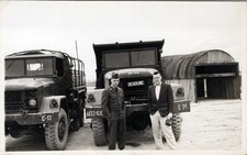 WW2 Photo Men Walking Near Military Trucks and Huts