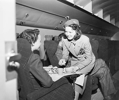Flight attendant serves a passenger a meal Food is prepared before- Old Photo