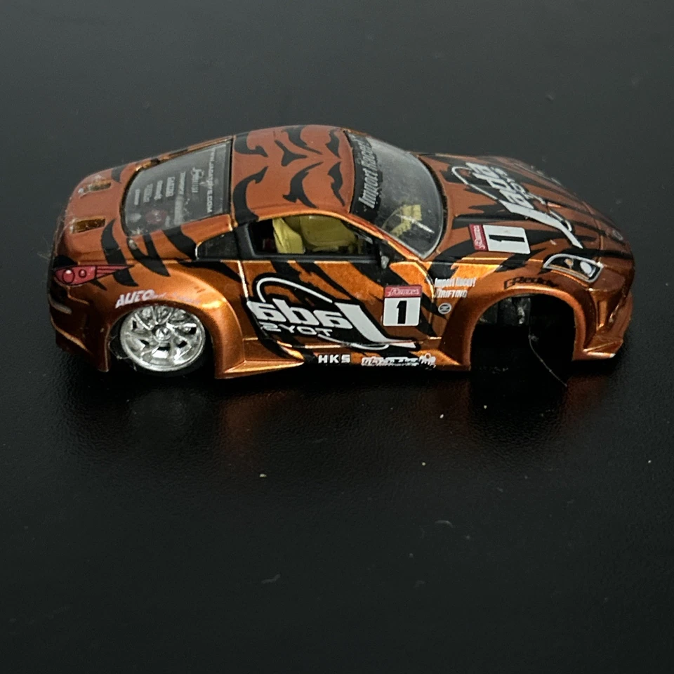 Rueda faltante JADA IMPORT RACER NISSAN Z COBRE/NARANJA 1:18 Foto 2 de 3