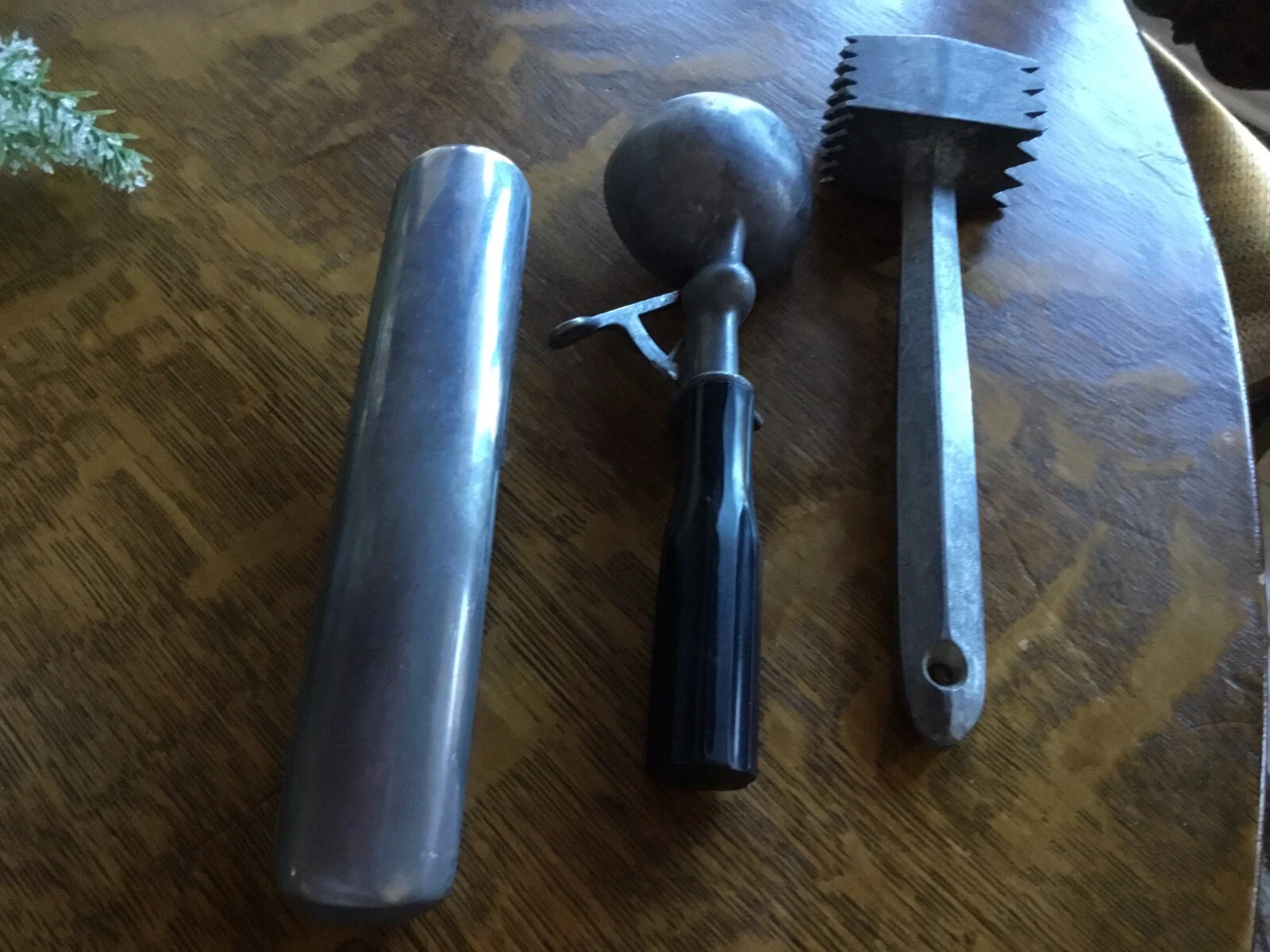 vintage garlic press, meat tenderizer, and ice cream scoop