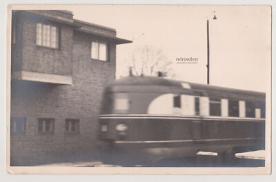 Blur of Progress Streamlined Train Races Past Silent Brick Station Abstract Phot