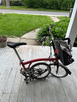 Brompton bike, fold up - slip under bed!! It is not electric- it s real deal