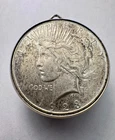 Pendant w/ 1923 Peace Dollar .900 Silver Coin with medallion frame.