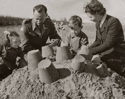 Major Mrs Wright with sons Jack David making sandcastles on the be- Old Photo