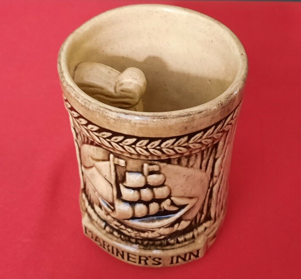 A Mariner's Inn mug with an inverse/inside-out handle — a genuine vintage joke item that baffles everyone who picks it up.