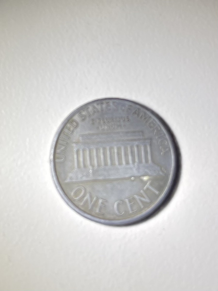 1987 Penny Unplated Planchet. coin that is lacking the copper