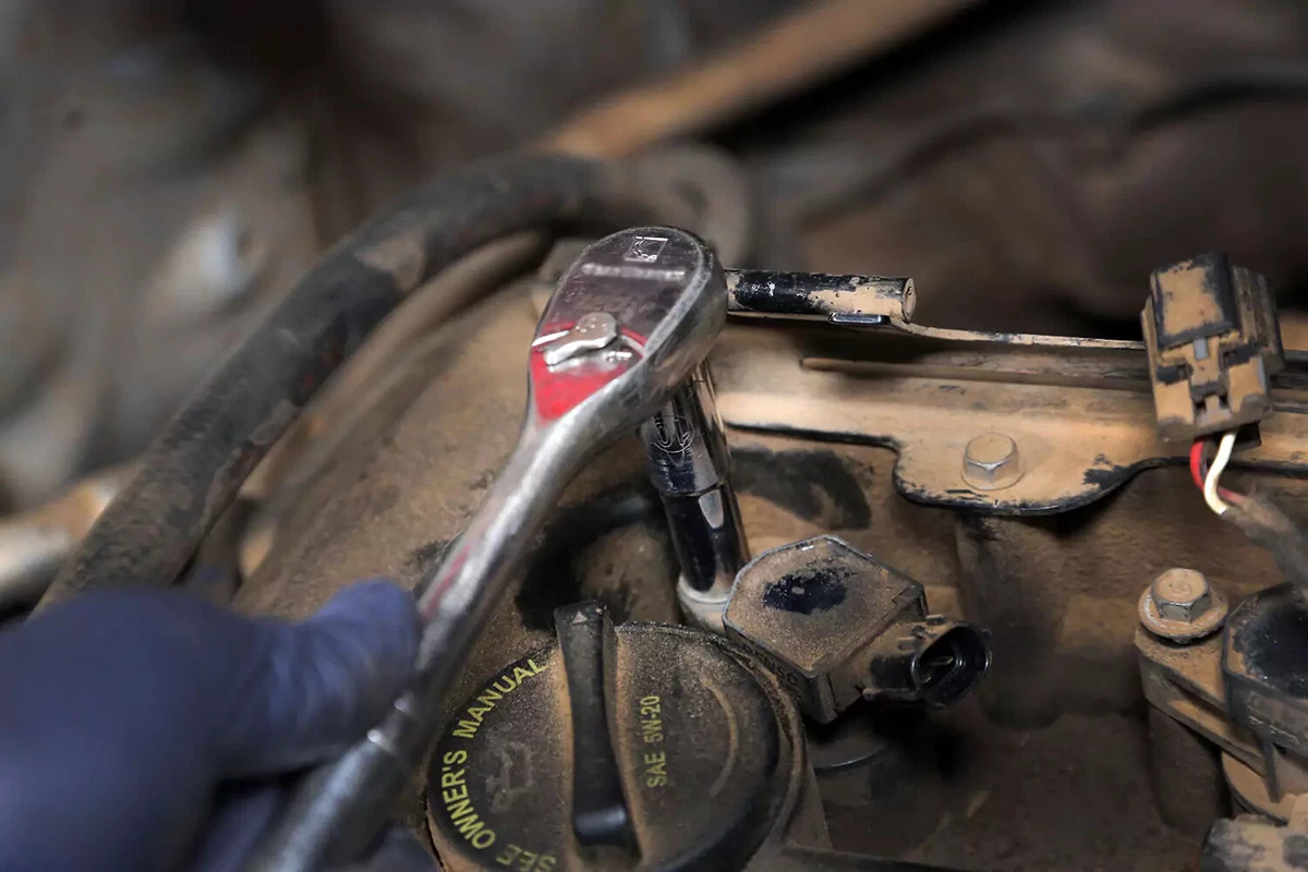 Coil hold-down bolt being tightened.