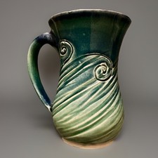 hand-thrown ceramic mug,  blue-green glaze wi...