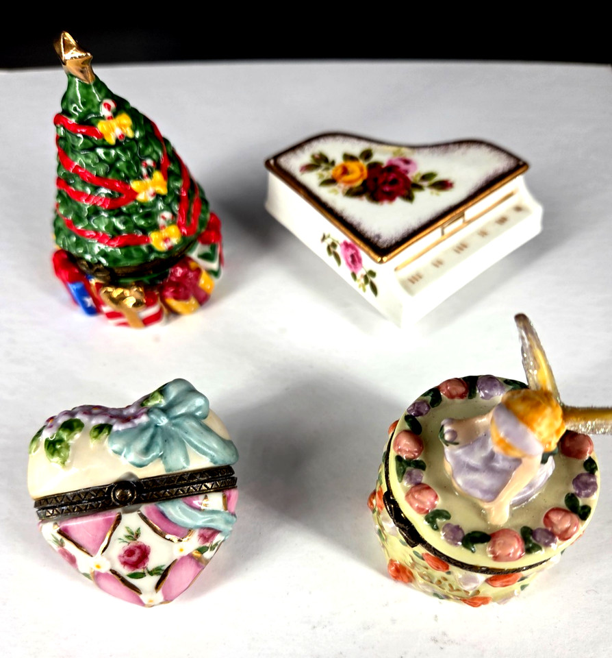 A set of four mismatched porcelain hinged trinket boxes — Tooth Fairy, Piano, Christmas, Heart — the kind of charming dusty-shelf treasure that's perfect for a quirky Secret Santa.