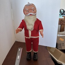 Vintage Santa Claus figurine with rubber face and fabric body