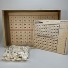 Vintage 1976 Classic Games Co. box with white script for “The Classic Game of KENO” and numbered red, yellow, and blue tokens.