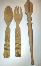 vintage hand-carved wooden salad server set with a spoon, a two-tined fork,