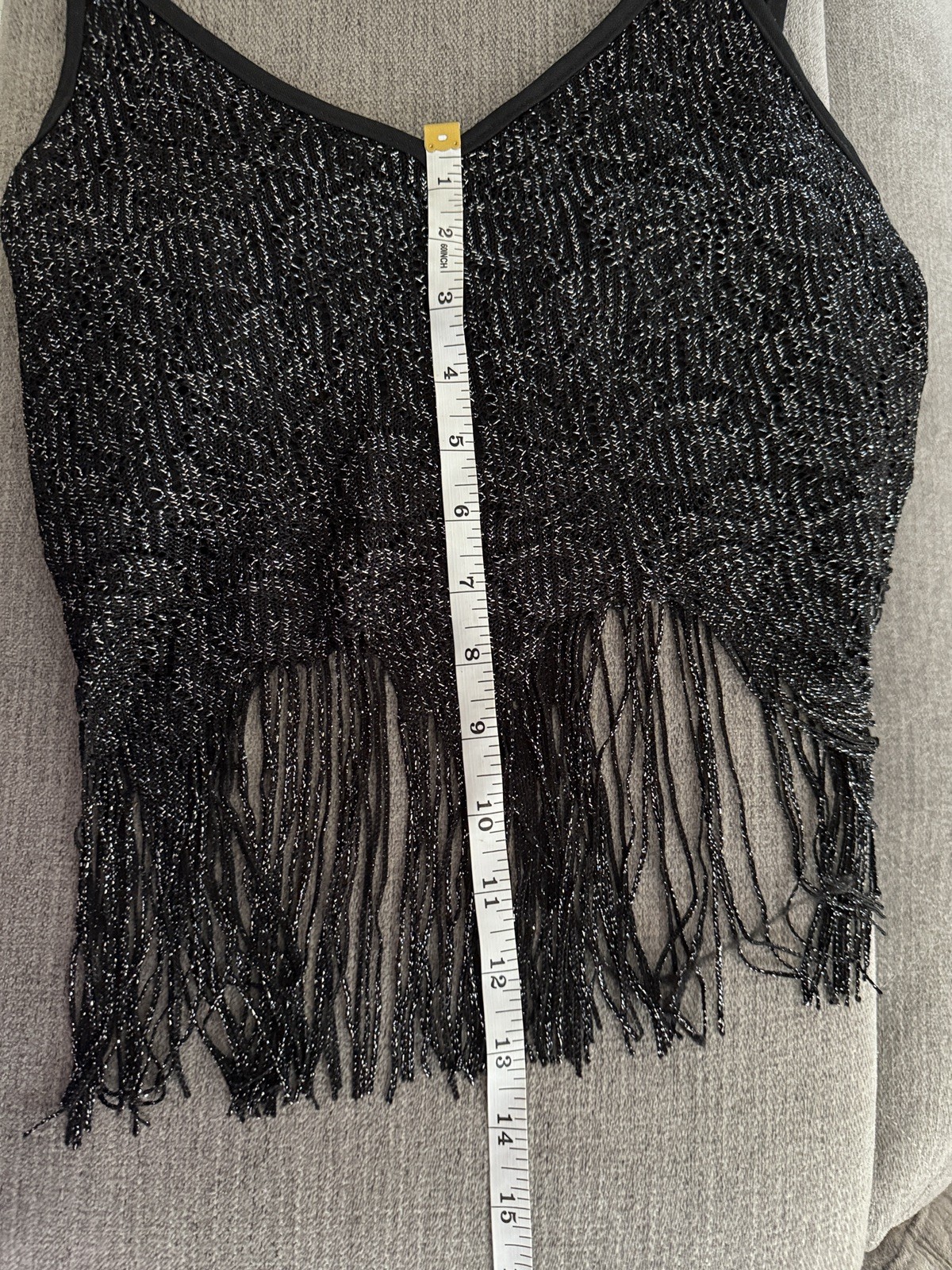 Black Y2K tank crop top with silver fringe, made in USA, shown on hanger against measuring tape.