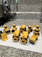 Toy Caterpillar Construction Fleet, Dump Trucks, And Others total Nine Pieces