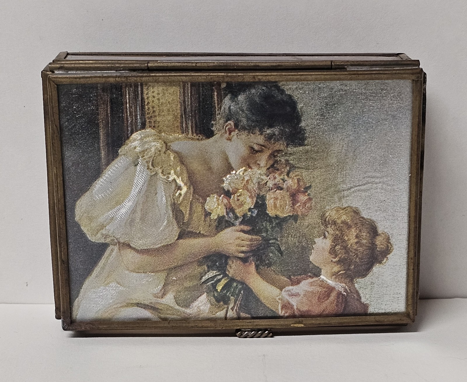 Small bronze Victorian mourning box with oval mirror lid and hidden picture mechanism.