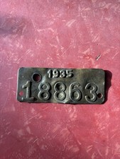 VINTAGE BRASS TAG, 1935 STAMPED 18863, MEASURES 3- 1/2" X 1 -7/16"