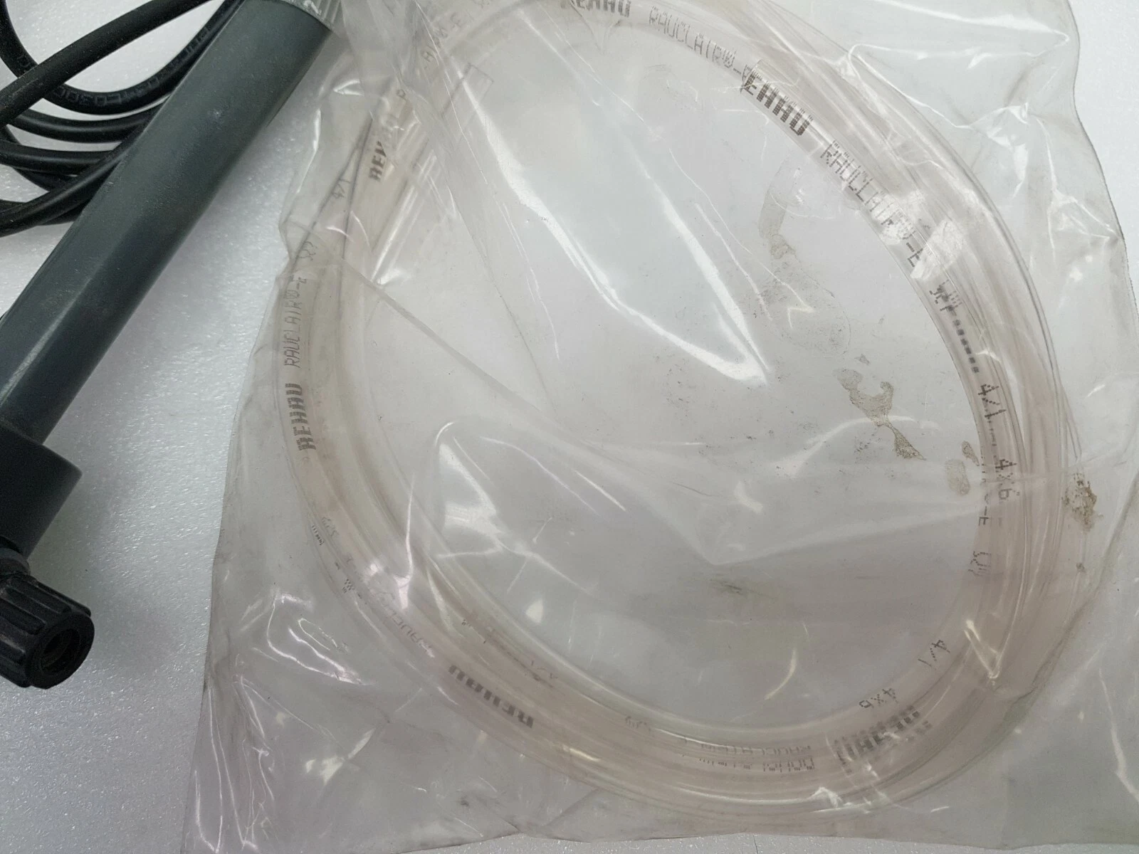 Bag of clear REHAU RAUCLAIR-E 4x6 suction tubing next to the lance