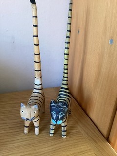 TWO WOODEN STRIPED BROWN & BLACK HAND PAINTED CAT FIGURINES WITH LONG TAILS
