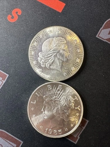(2) Round Lot .999 Fine Silver 1oz | Worldwide Mint, 1981 & 1985 Peace Dollar