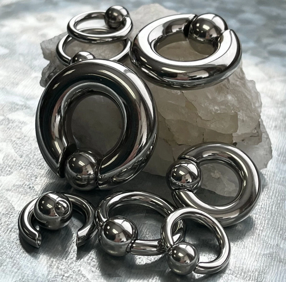 Spring loaded captive bead ring deals