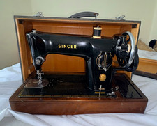 vintage black Singer 201K sewing machine with a wooden base and carrying case