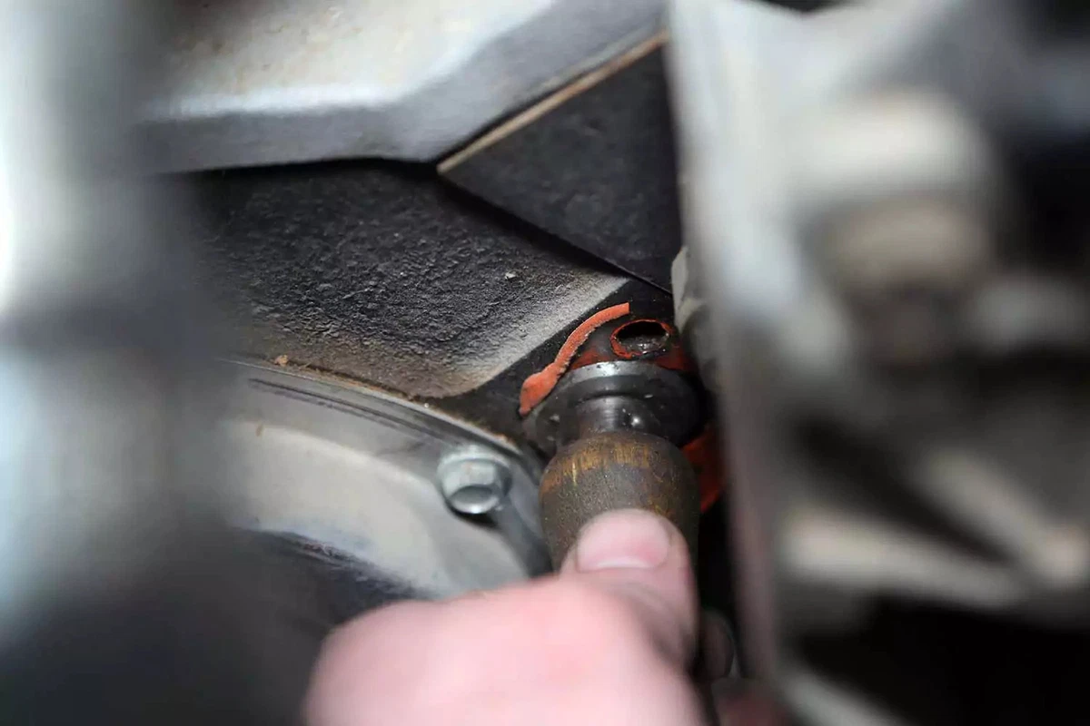 Residue is removed from the engine block with a gasket scraper.