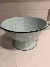 robin's egg blue enamelware colander with contrasting black Trim