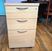 Lockable 3 Drawer Wooden Filing Cabinet Pedestal  With A Brown Wood Effect.