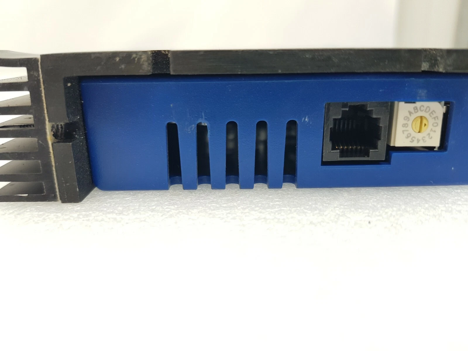 Side of the Accelnet 800-1656 with RS-232 port, CAN address rotary switch and finned heatsink