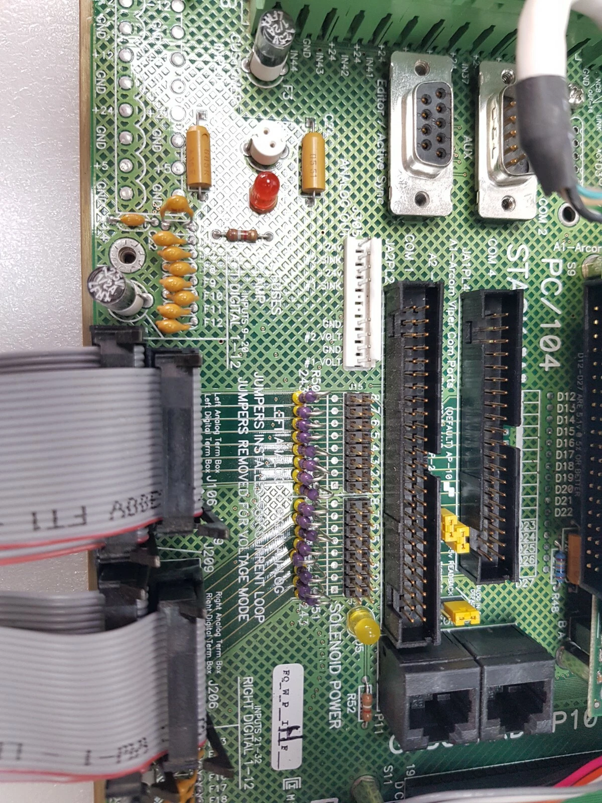 PC/104 stack area of the AP10 System I/O board with two 9-pin D-sub connectors and ribbon cables