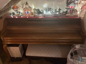 Beautiful vintage Kimball upright console piano with a warm walnut wood finish.