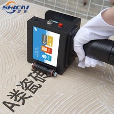 5cm handheld inkjet printer prints images, text labels, barcodes logos and dates