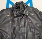 Black vintage leather Langlitz motorcycle jacket with snap buttons, front zipper, and two slit pockets, size 46.