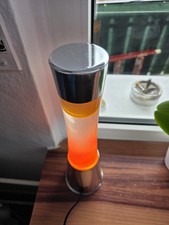 Fisura - Lavalampe orange. Silberner Chromsockel, orangefarbene Fluessigkeit 