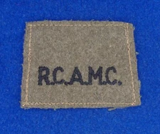 "R.C.A.M.C."  Epaulette/shoulder flash.  Black on khaki wool. Original