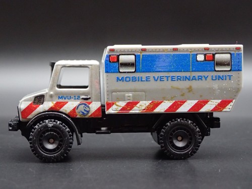 Mercedes-Benz Unimog U 1300L Jurassic World Ifp Unità 1:64 Scala Modellino - Foto 2 di 7