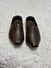 Vintage, dark-stained wooden Dutch clogs hand-carved from a single piece of wood
