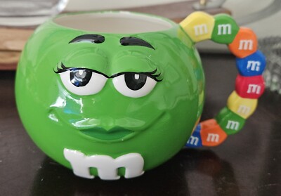 Green M & M Coffee Mug. Candy Handle. Few Small Chips. 